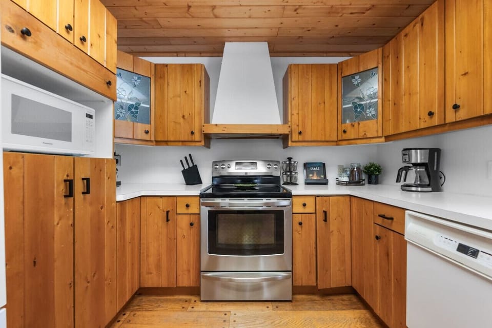 Full kitchen with a drip & espresso coffee machine and a kettle.