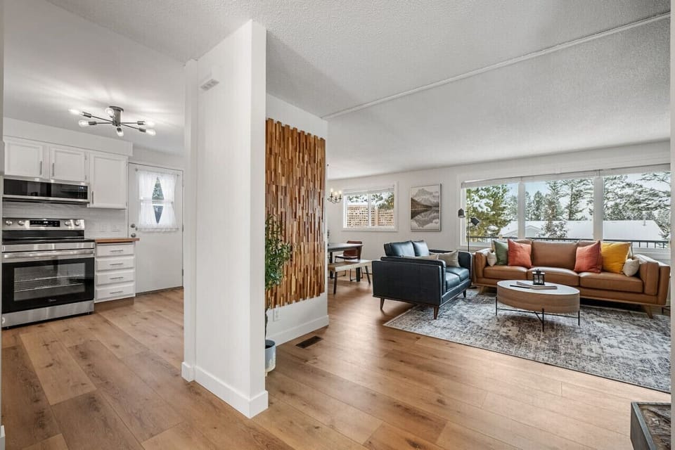 Living room with a smart TV, gas fireplace, board games & cozy seating options.