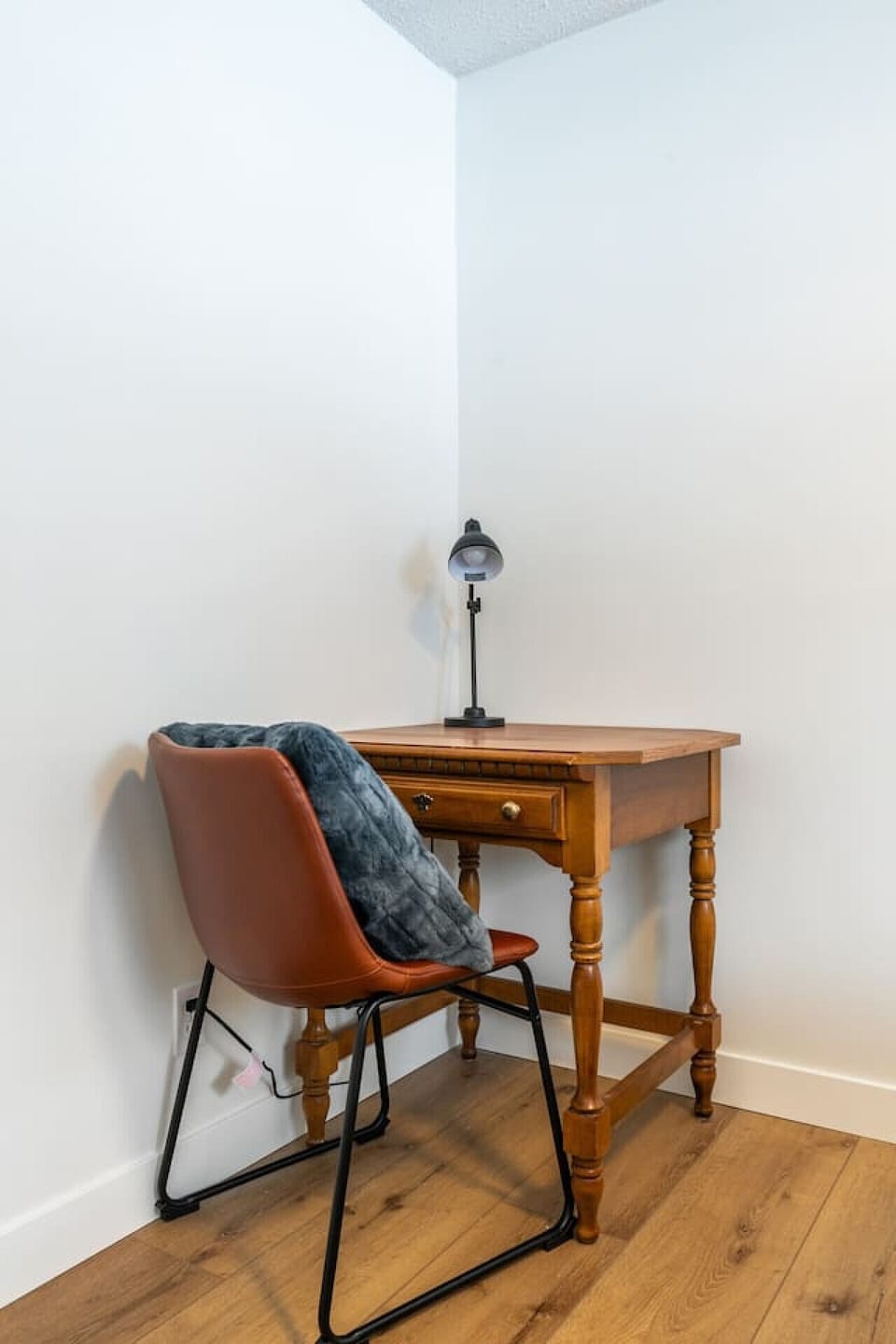 Second bedroom on the main floor with a queen bed, a dedicated workstation, dresser, blackout curtains & a closet.
