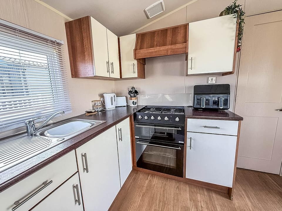 Enjoy a relaxing staycation UK at Park Holidays UK Broadland Sands, where the cosy kitchen area in a caravan makes family meals a breeze after a day exploring Suffolk beaches.
