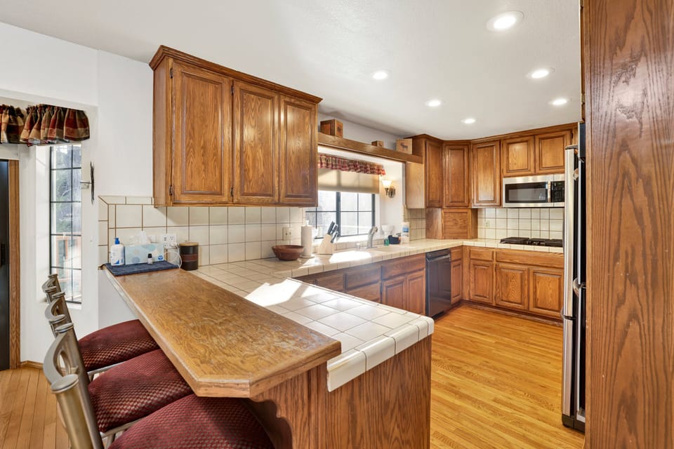 Fully equipped cabin kitchen with ample cabinetry, stove, fridge, microwave, and coffee maker—perfect for cooking meals, morning coffee, and feeling right at home on your stay.