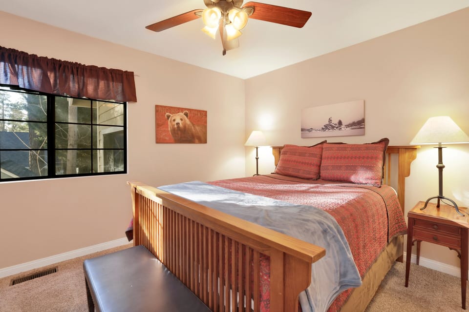Peaceful cabin bedroom with plush bedding, and beautiful views—ideal for restful nights, cozy mornings, and a relaxing mountain escape.