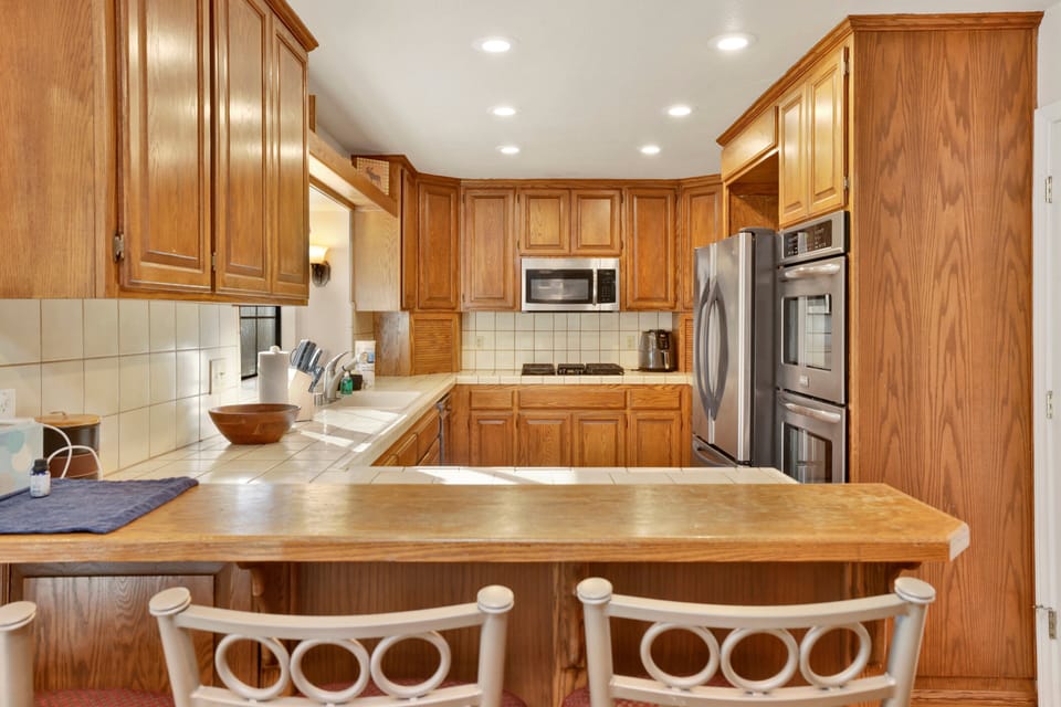 Fully equipped cabin kitchen with ample cabinetry, stove, fridge, microwave, and coffee maker—perfect for cooking meals, morning coffee, and feeling right at home on your stay.