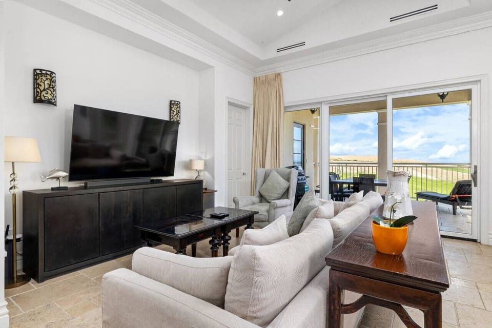 Relax in style with a cozy sofa and entertainment-ready TV, all set within a spacious living room that blends comfort with modern design.