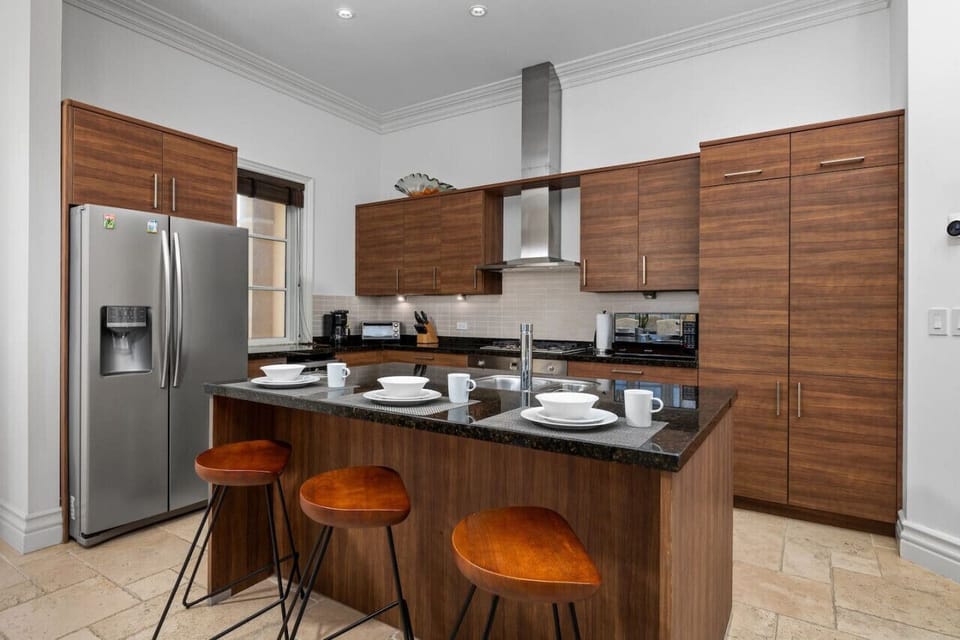 Cook and entertain in style with this spacious kitchen featuring a central island, perfect for meal prep and gathering with loved ones.