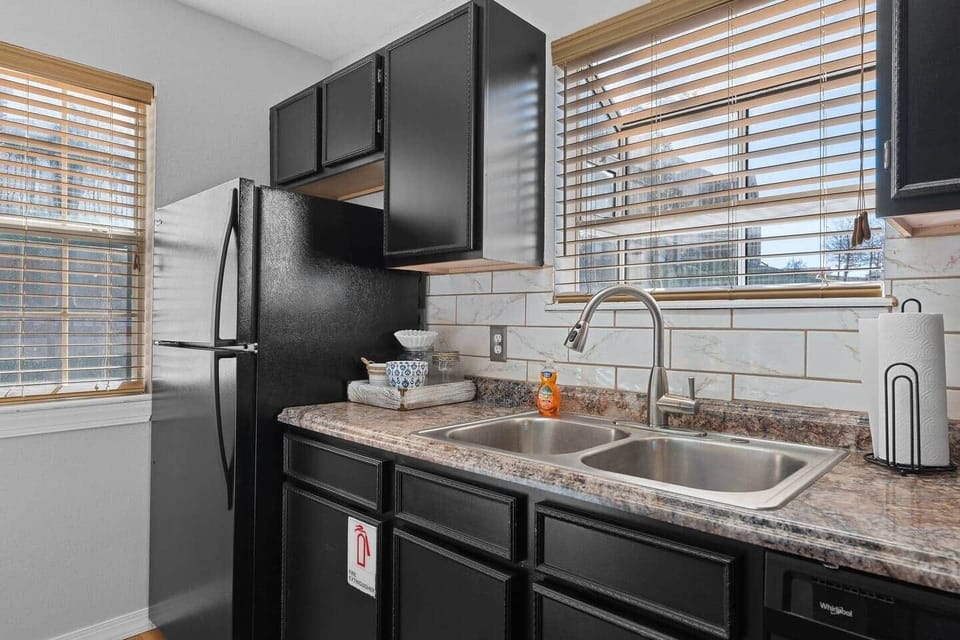 Full kitchen with fridge.