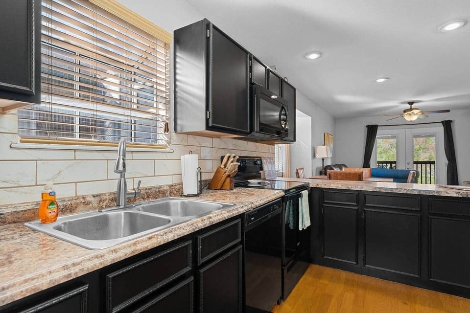 Full kitchen with dishwasher, stove, oven and microwave.