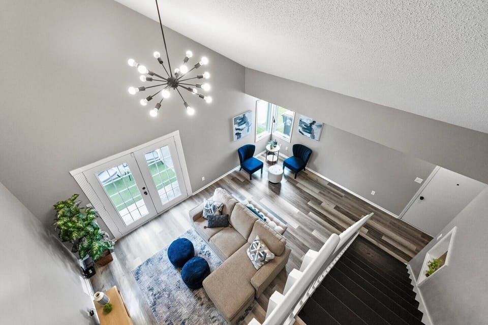 Stunning aerial view showcasing the expansive, open-concept living room with comfortable seating and stylish decor.