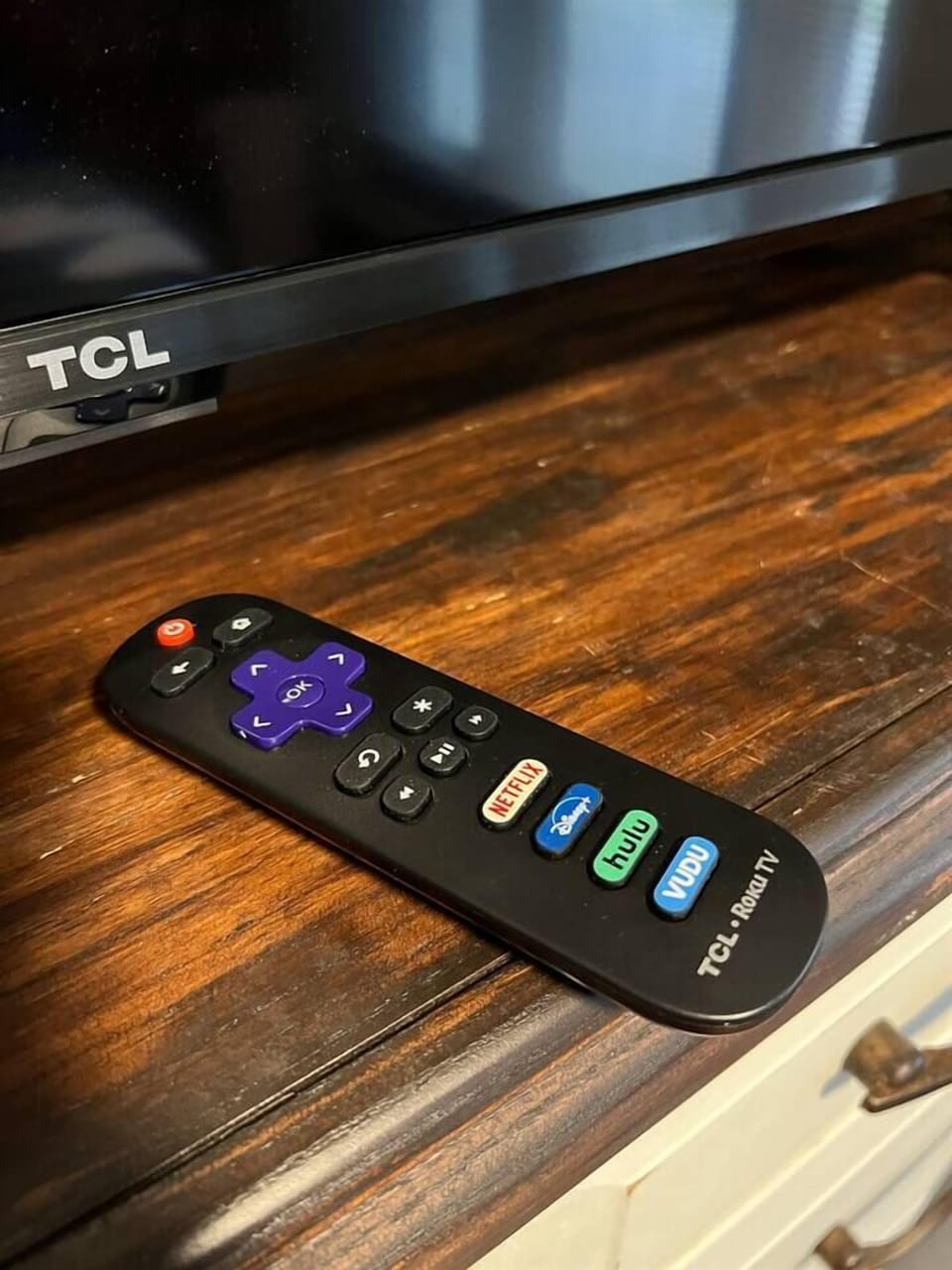 Cozy bedroom featuring a remote for the widescreen TV, adding convenience to the modern design. This inviting space blends comfort and functionality, creating the perfect environment for relaxation and entertainment