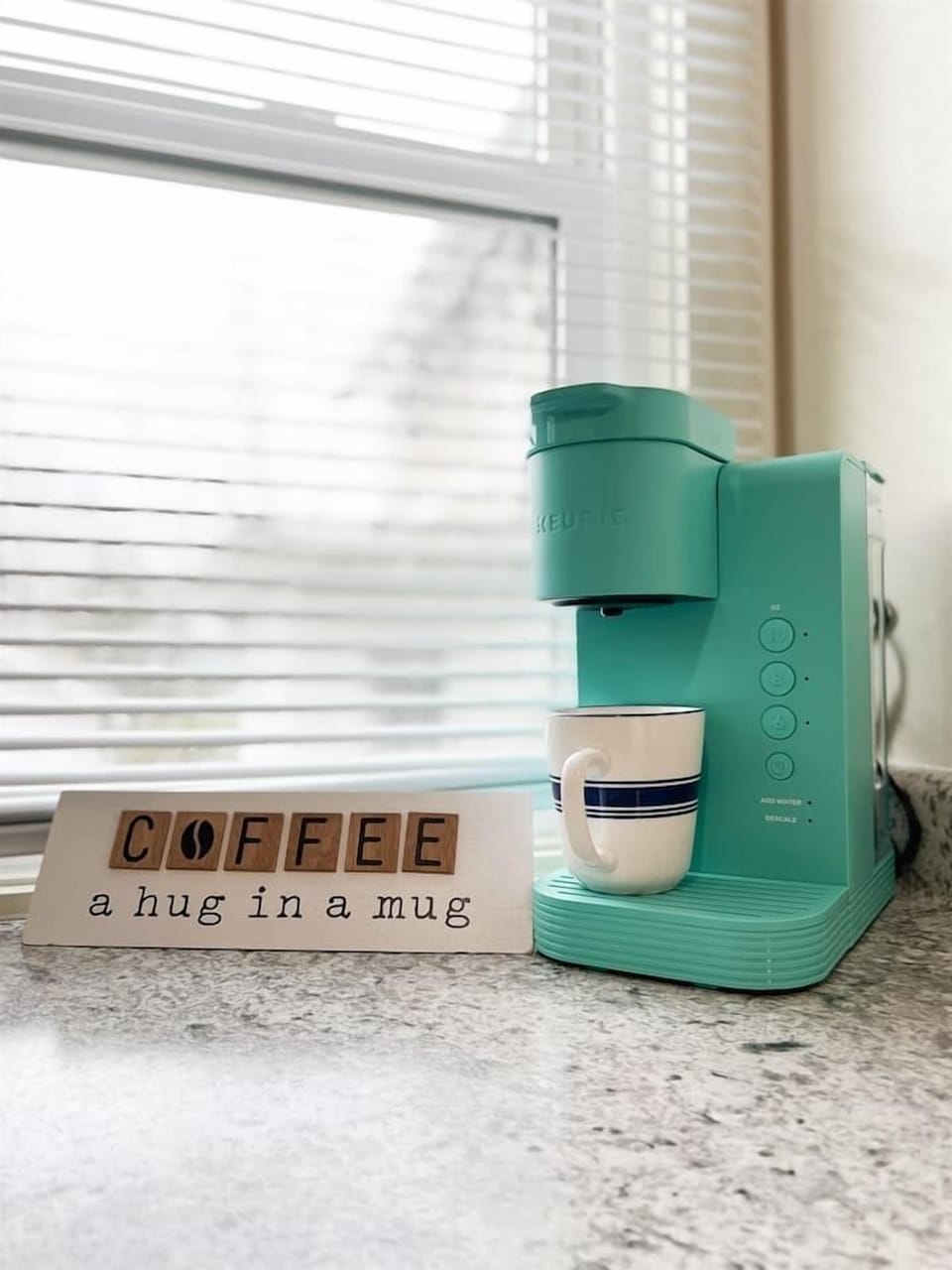 Full kitchen featuring a sleek coffee maker, perfect for coffee lovers, with a motivational touch to inspire the love of coffee. A cozy, functional space designed for brewing your favorite cup and adding warmth to your kitchen experience