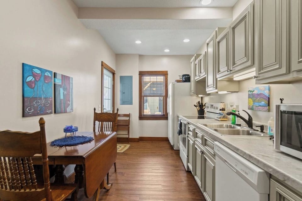 Open-concept kitchen and dining area, featuring modern appliances, ample seating, and a welcoming atmosphere for shared meals.