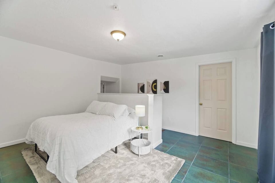 Cozy double bed with a soft carpet underneath, providing a comfortable and inviting space for a restful night's sleep.
