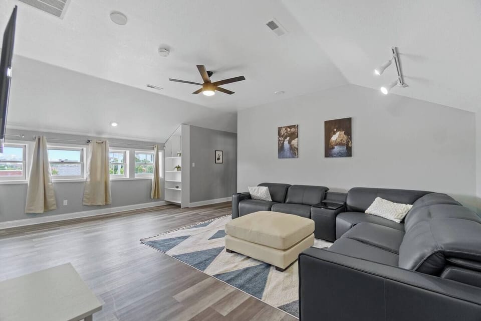 Spacious living room with comfortable couches and large windows, allowing plenty of natural light to fill the room and create a bright, airy atmosphere.