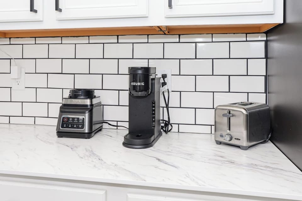 Keurig coffee maker, blender, and toaster for your convenience, perfect for preparing breakfast or a quick snack.