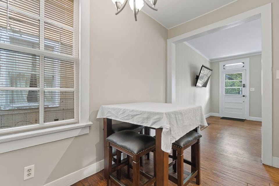 Charming four-seater dining area with stylish stool chairs, offering a cozy space for casual meals or enjoying a drink in a modern, open setting.