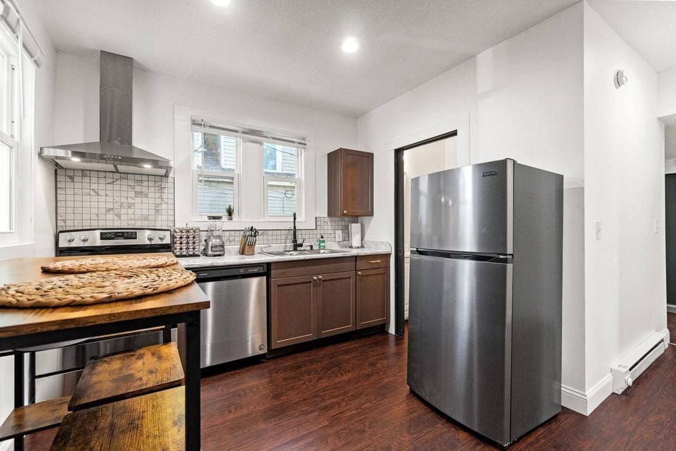 Spacious kitchen with stainless steel appliances, sleek countertops, and ample cabinet space. Perfect for cooking and gathering in a modern, inviting atmosphere!