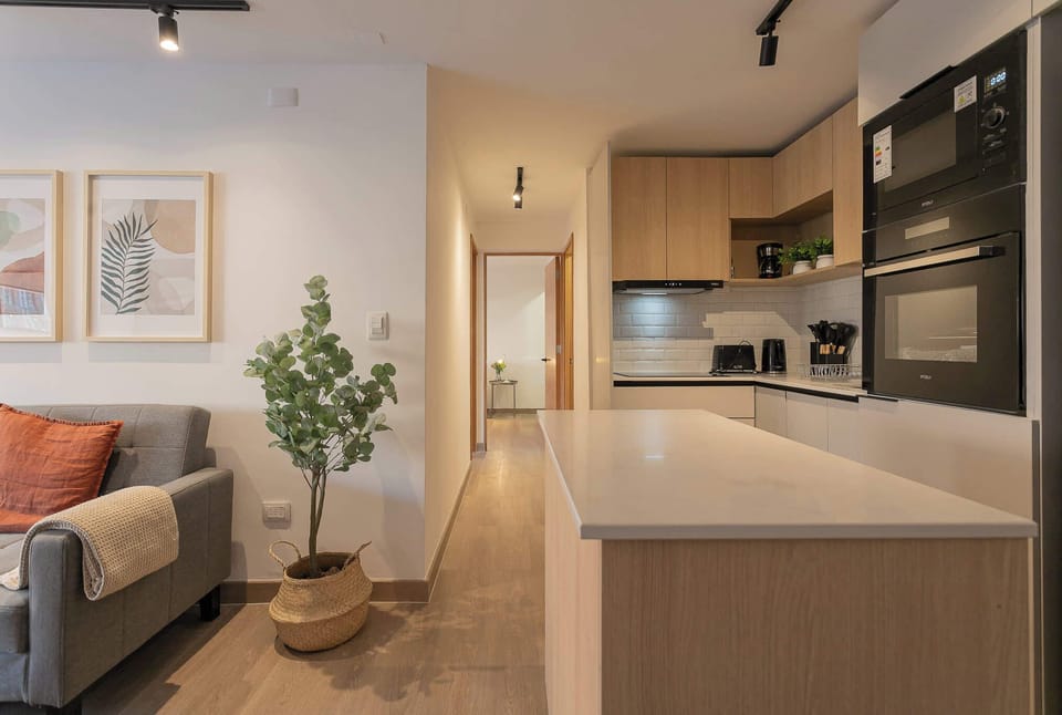 Experience modern comfort in this stylish kitchen and living area, perfect for relaxing or entertaining.