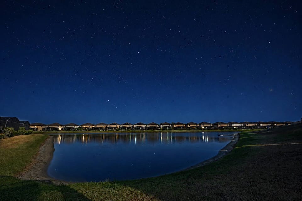 Nighttime view of lakeside homes under a star-filled sky