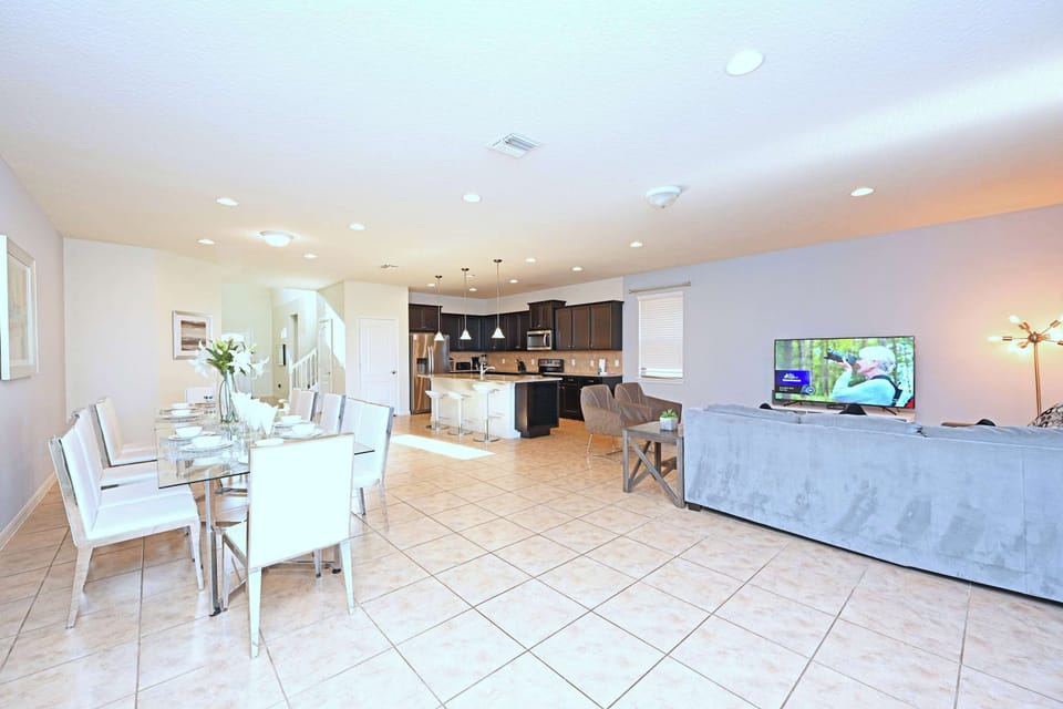 Open-concept living and dining area with modern kitchen and ample seating