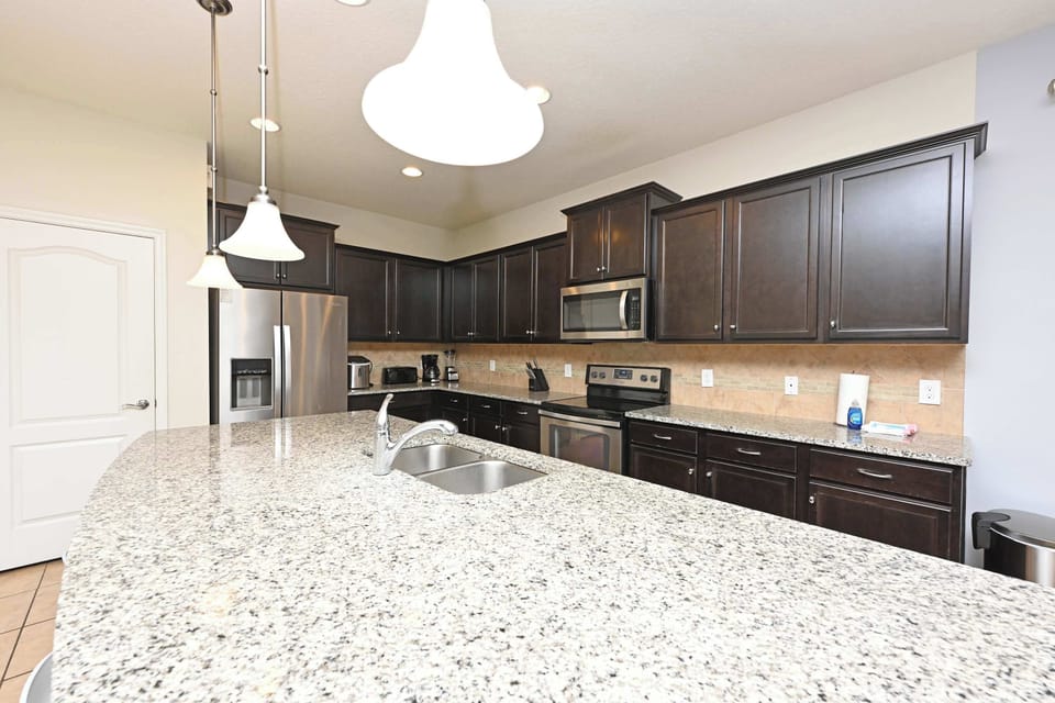 Modern kitchen with granite countertops and dark wood cabinets