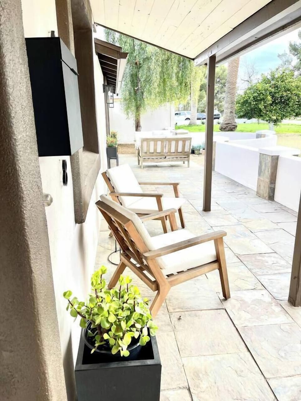 Front patio with spacious seating and a lush, grass-covered yard for relaxation.