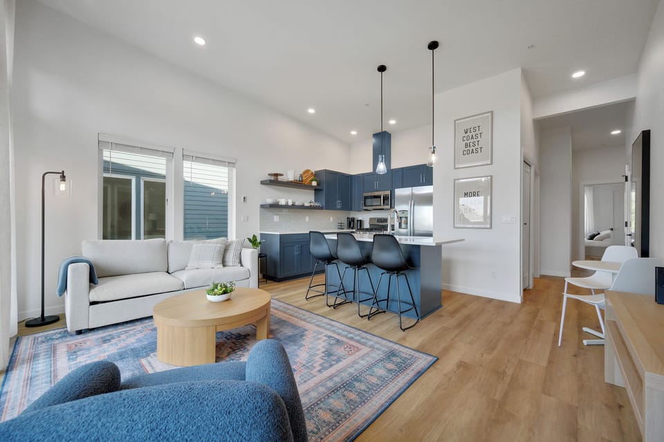 Island bar seating, two seat bistro table, and comfortable living room. 
