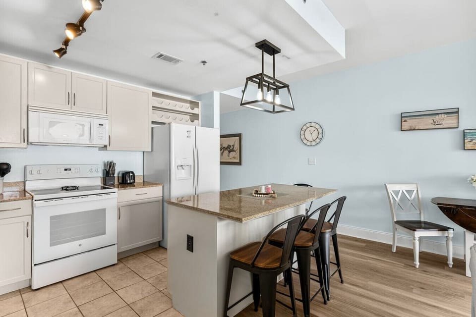 Open Concept, Fully Stocked Kitchen with Fridge, Freezer, Stove, Microwave, Drip Coffee Maker and Island Bar Seating