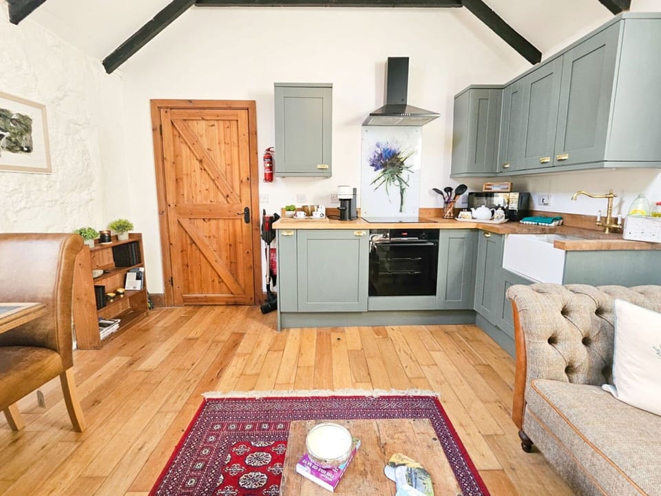 Furniture, Interior Design, Flooring, Countertop, Cabinetry, Kitchen, Kitchen Appliance, Wood, Floor, Major Appliance