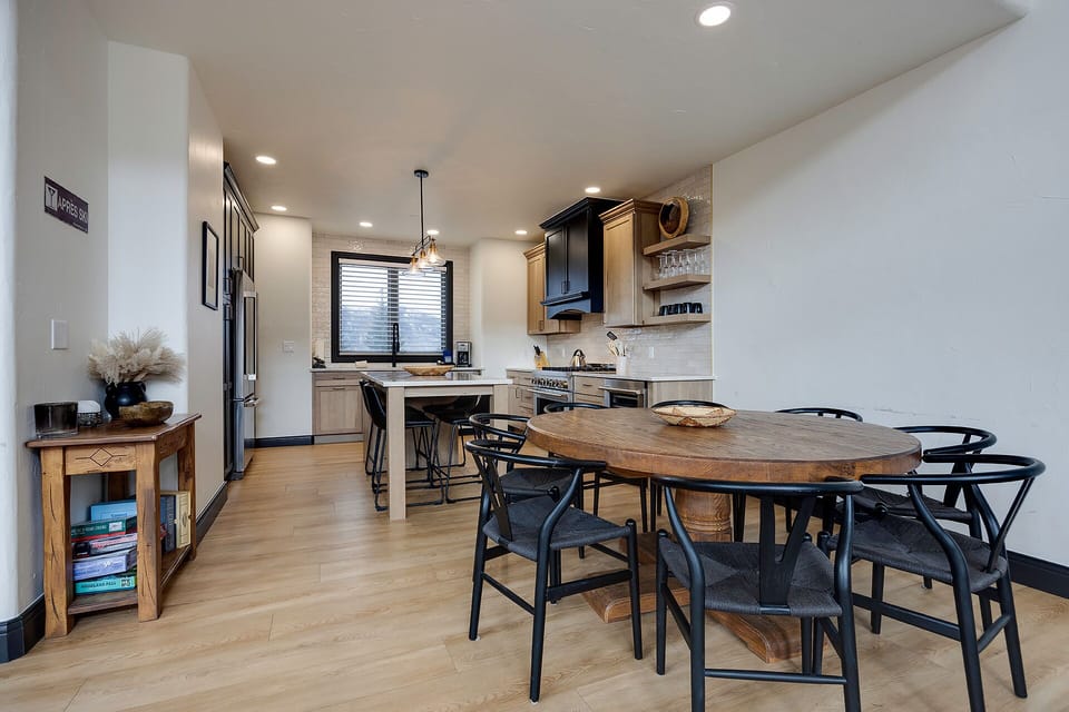 Your stylish open kitchen flows seamlessly into the dining area, where warm wood tones and modern fixtures create the perfect space for cooking and gathering.