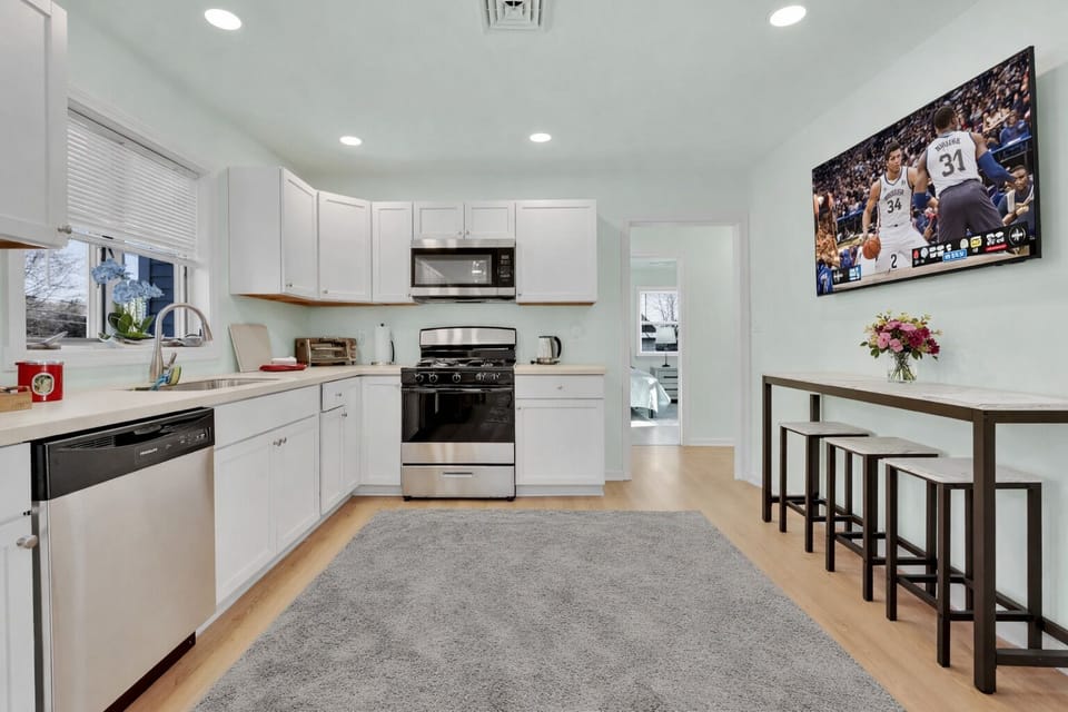 Bright & Modern kitchen with brand new appliances. 3 Bar stools for quick meals.
