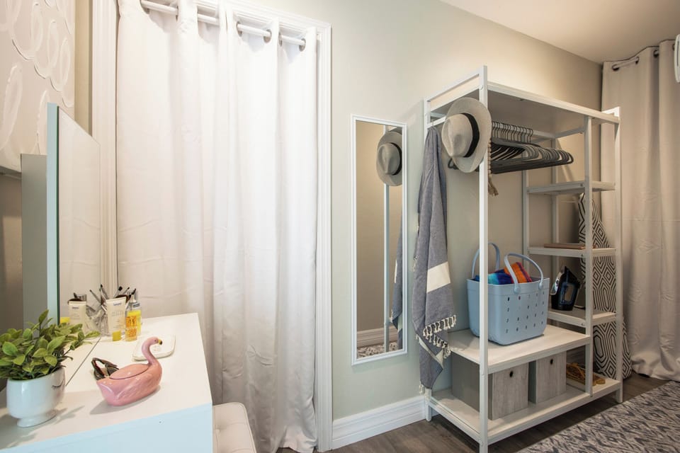 Your primary suite also offers you your own private dressing area, complete with shelves and hanging space for all your getaway essentials—hats, swimsuits, flip flops, and vacation wear all in easy reach.
