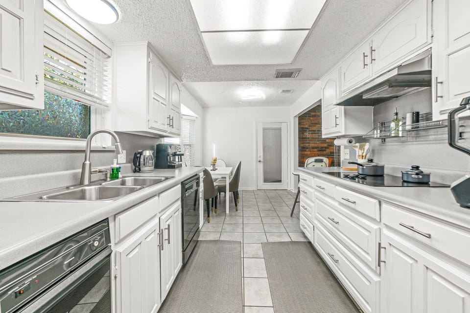 “Spacious kitchen with modern appliances, ample storage, and dining space.”