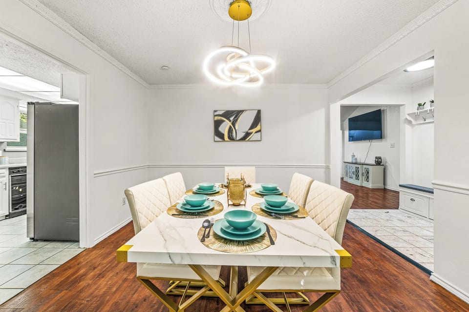 “Elegant dining room with a modern table setting and stylish lighting.”