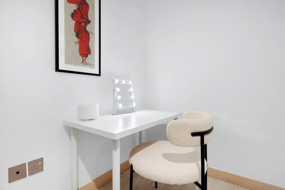 Workspace Oasis: Sleek desk and chic chair await your creativity in this artistic retreat!
