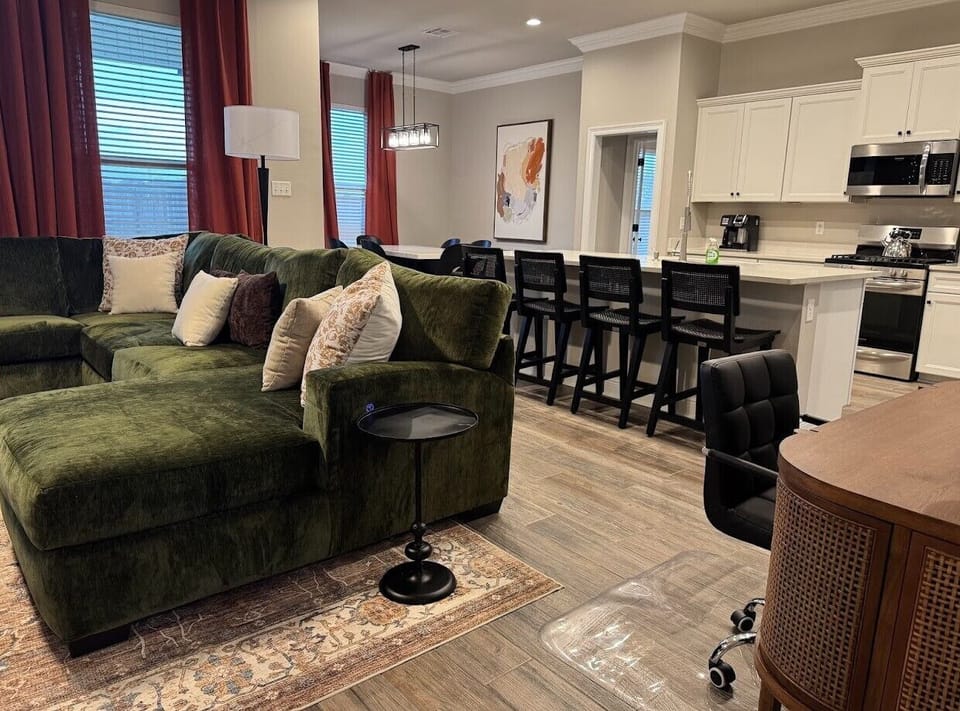 Experience the seamless flow of this expansive open-concept living space, offering effortless access to the living room, dining area, and kitchen. Professional photos coming soon.
