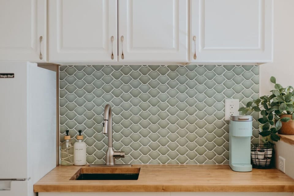 Cozy kitchen sink with cabinet, keurig and fridge