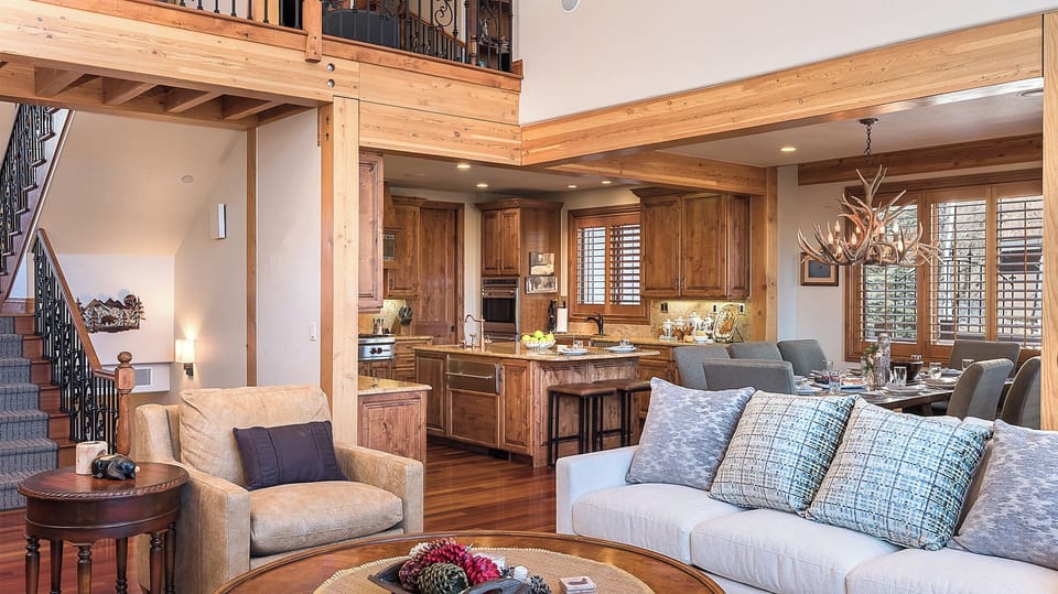 Great Room, Main Level - Inviting lounge space with exposed beams and adjacent kitchen