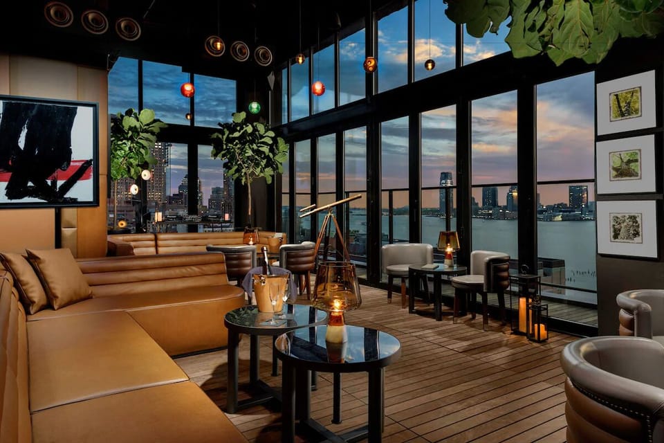 Unwind at sunset with skyline views and cozy lounge seating.