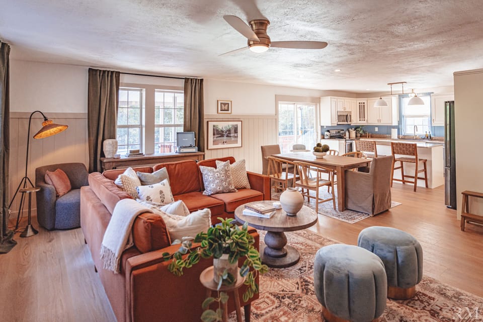 Open-concept, cozy living room with a sectional sofa and a 65" Roku smart TV