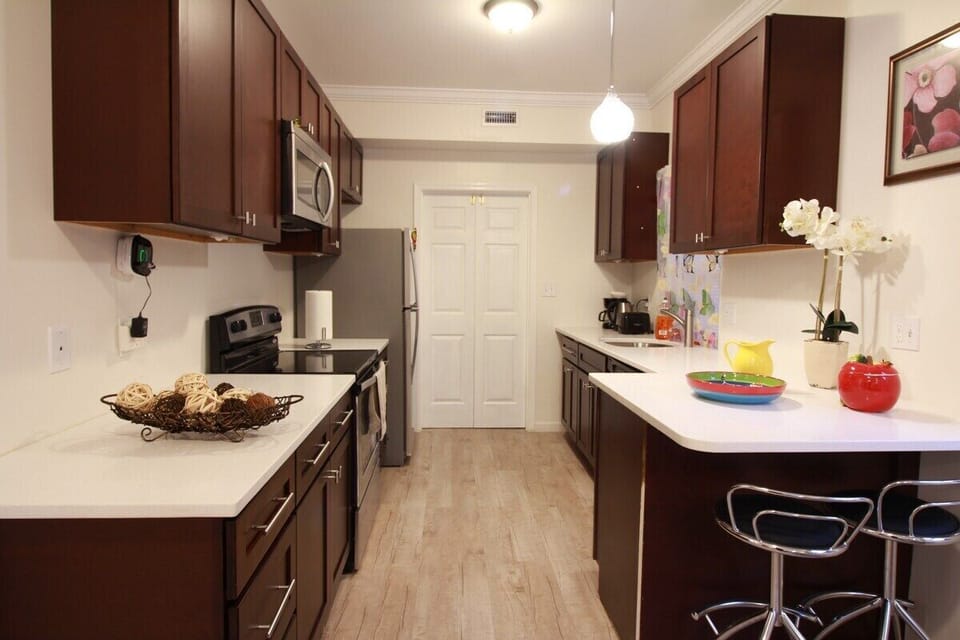 large washer and dryer behind double door in the sunroom and back entry area