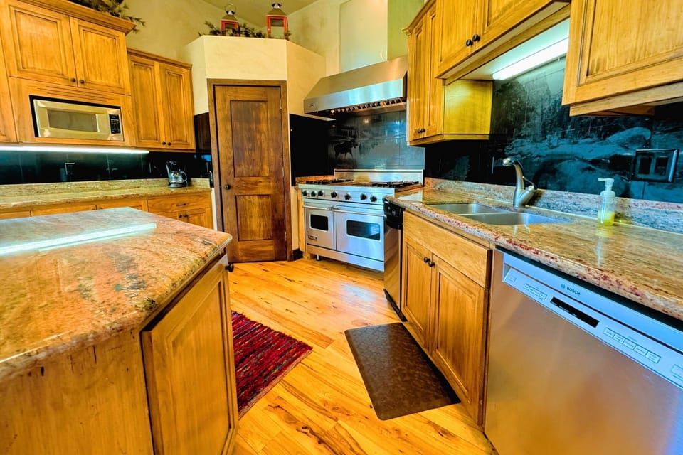 Cook gourmet meals in the fully equipped kitchen, then enjoy them in the elegant dining area with mountain charm.