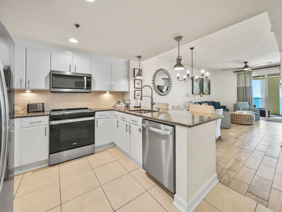 Your fully equipped kitchen flows seamlessly into the living space, perfect for preparing meals while staying connected with your group.