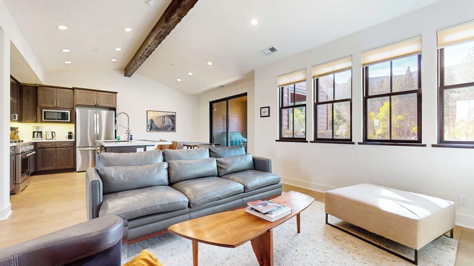 Bright living space with cozy seating and Smart TV