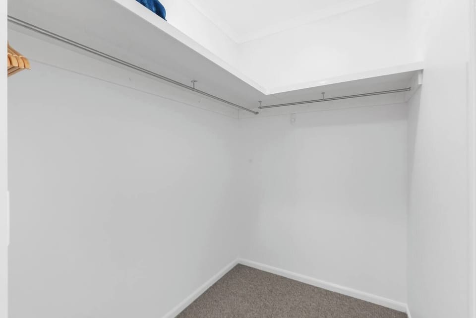A walk-in robe offers ample space to store your luggage and belongings.