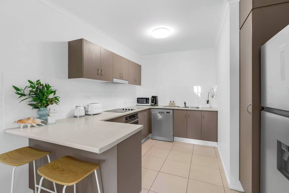 Prepare meals with ease in the fully equipped kitchen, boasting modern appliances, a large pantry and a breakfast bar.
