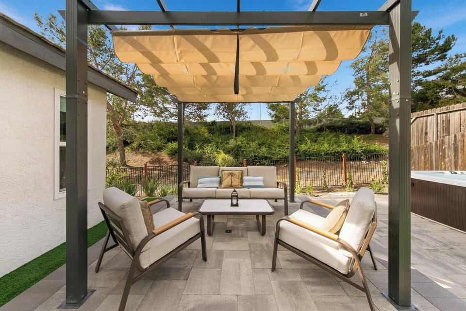 Backyard seating area under charming pergola