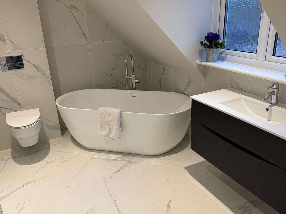 Master bedroom en suite bathroom with bath and shower. 