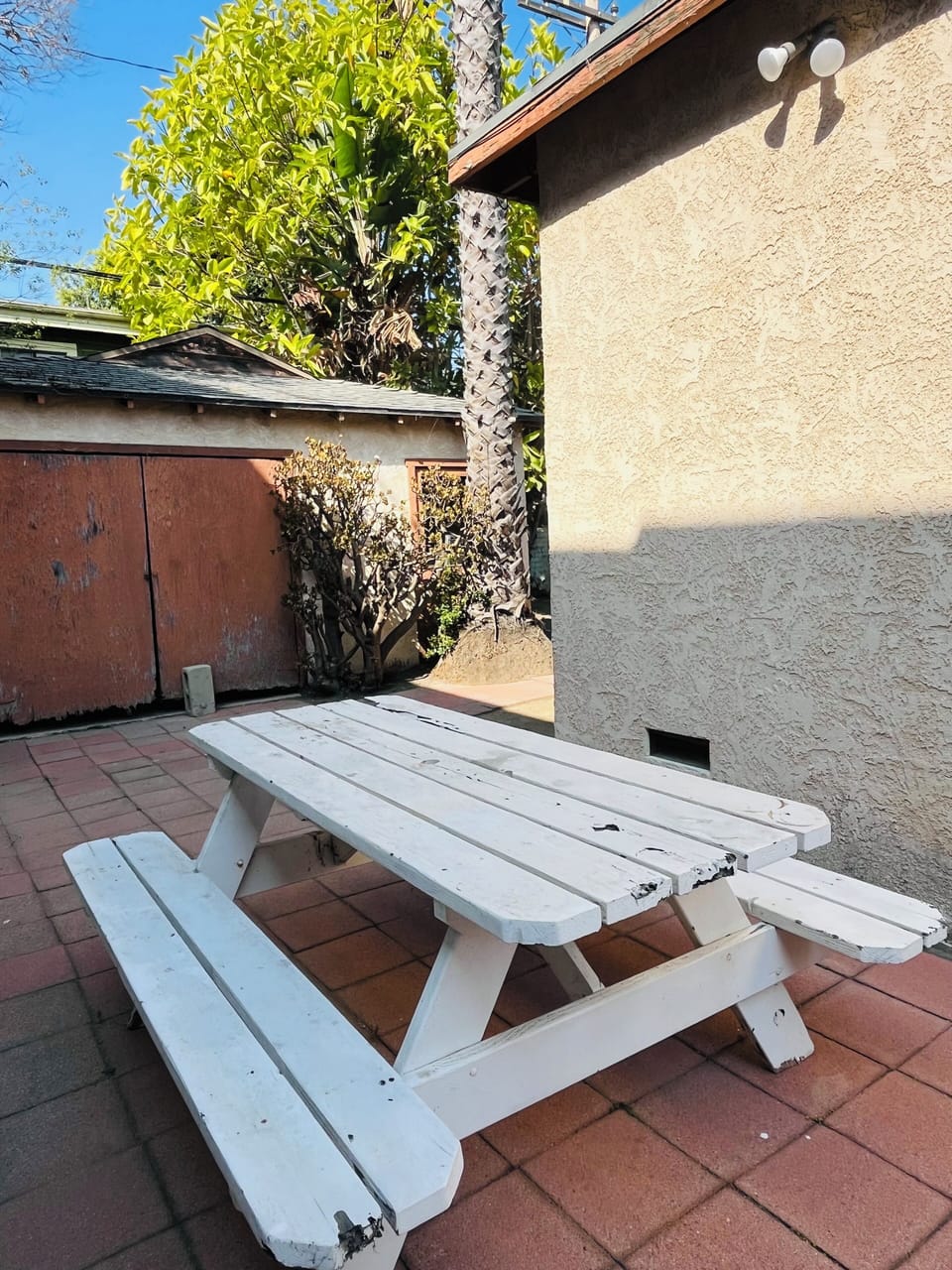 Outdoor dining/cocktail area. in the BG, storage and washer/dryer space.