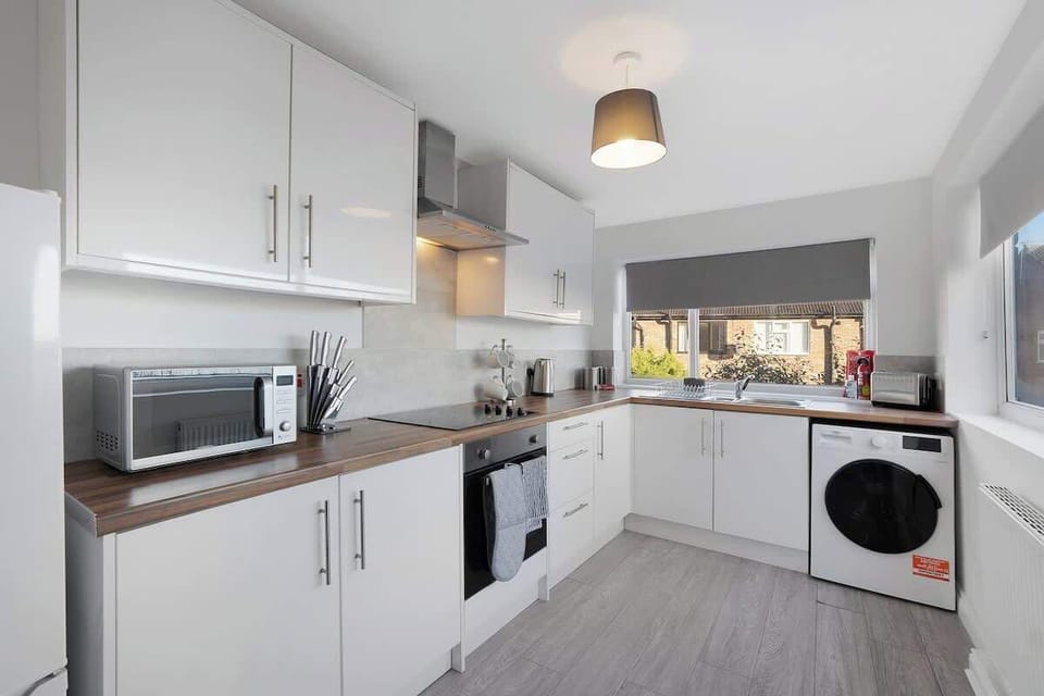 Kitchen equipped with all essentials, including a washer & dryer, oven, fridge and full cookware set.