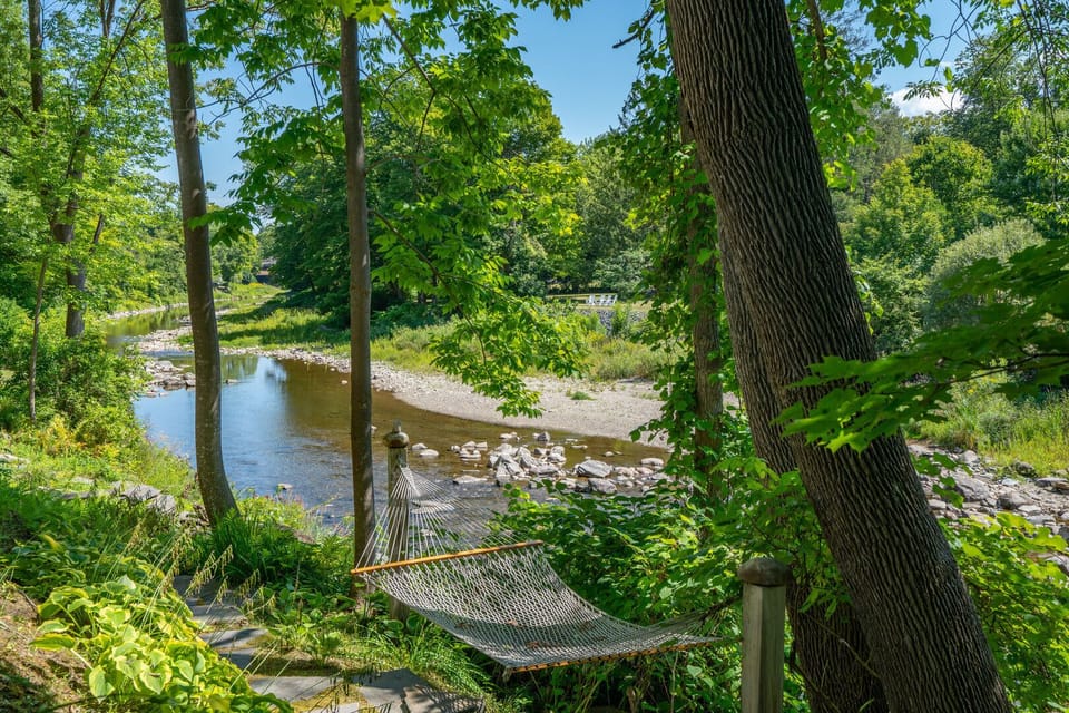 Relax in the riverside hammock overlooking the Ottauquechee River